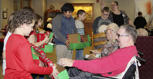 Buddy Up Students and Maple Lawn Residents pack Operation Christmas Child boxes